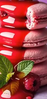 Stack of pink macarons with raspberry sauce and mint garnish.