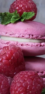 Stack of raspberry macarons with fresh mint leaves, perfect as a wallpaper.