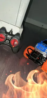 RC monster truck with fiery orange wheels on the floor.