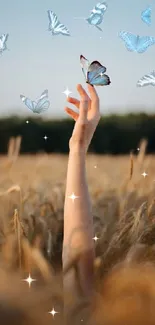 A hand reaches for blue butterflies in a golden field under a clear sky.