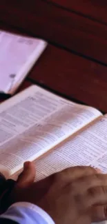 Open book on a wooden table, perfect for reading enthusiasts.