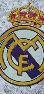 Real Madrid emblem on textured background.