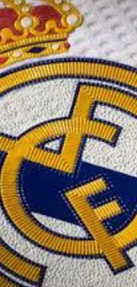 Real Madrid logo on textured jersey background.