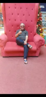 Person sitting on a large red chair.