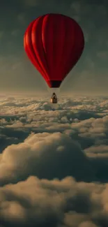 Red hot air balloon soaring above clouds.