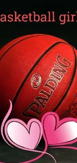 Red basketball with pink hearts on dark background wallpaper.