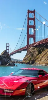 Classic red car with Golden Gate Bridge in background.