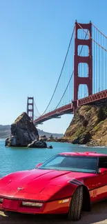 Red car with Golden Gate Bridge in the background on a sunny day.