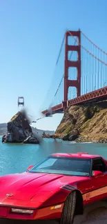 Red sports car parked near Golden Gate Bridge under blue sky.