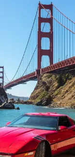 Red sports car with Golden Gate Bridge backdrop.