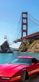 Red sports car by Golden Gate Bridge with blue sky.