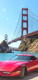 Red sports car with Golden Gate Bridge in a clear blue sky background.