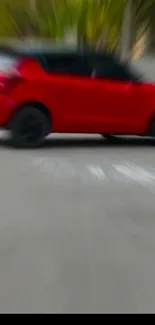 Blurred red car moving fast on road wallpaper.