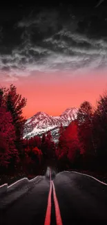 Red-tinted mountain road at sunset with dramatic sky.