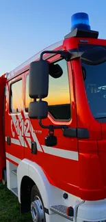 Bright red firetruck wallpaper with a blue sky backdrop.