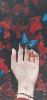 Hand reaching into red foliage with blue butterflies landing gracefully.