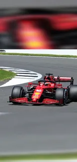 Vibrant red Formula 1 car racing on a track with blurred background.