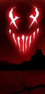 Red glowing horror face on a dark landscape wallpaper.