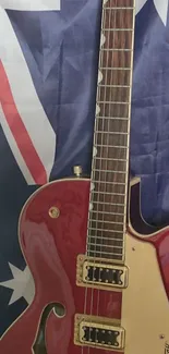 Red electric guitar on Australian flag background.