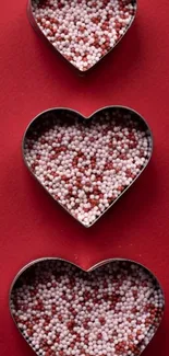 Heart-shaped candies on red background wallpaper.