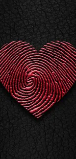 Red fingerprint heart on textured black background.