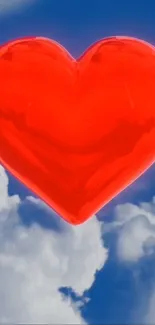 Vivid red heart floating in a blue sky with white clouds.