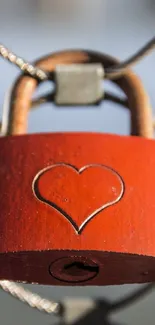 Red lock with heart engraving on a cable.