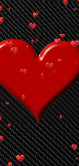 Red heart on carbon fiber background with smaller hearts.