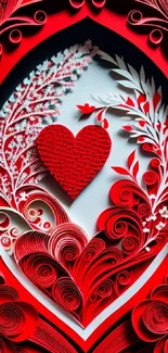 Intricate red heart paper art design with floral and decorative patterns.