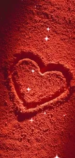 Red heart drawn in rich sand texture background.