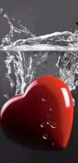 Red heart splashes into water on dark background, stylish wallpaper.