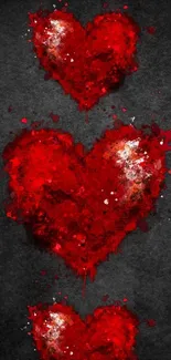 Three vibrant red hearts on dark background mobile wallpaper.