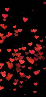 Wallpaper with scattered red hearts on black background.