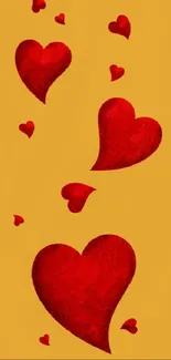 Mobile wallpaper with red hearts on golden background.