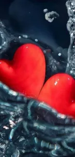 Two red hearts splash in water against a dark blue background.