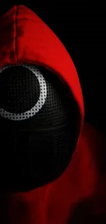 Mysterious figure in red hood with black mask on dark background.