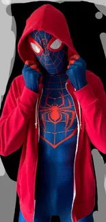 Red hooded superhero in blue suit on graphic background.