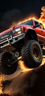 Red monster truck with fire background jumping off a ramp in dynamic display.