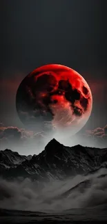 Stunning red moon over misty mountains and clouds, perfect for phone wallpaper.