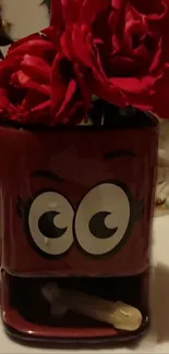 Red mug with cartoon eyes filled with roses.