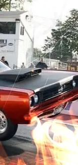 Red muscle car lifting at racing track event.