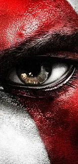 A close-up view of an eye with a striking red paint design.