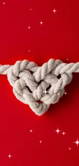 Red backdrop with heart-shaped rope knot.