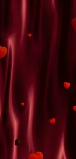 Luxurious dark red satin wallpaper with floating red hearts.