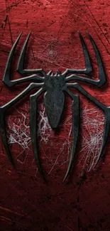 Wallpaper of a black spider emblem on a red textured background.