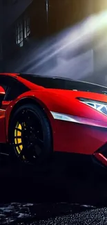 Red sports car illuminated in a dark, urban night setting.