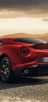 Stunning red sports car with sunset backdrop.