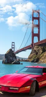 Red sports car parked by Golden Gate Bridge with clear sky.