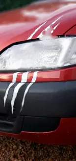 Close-up of a red sports car with white racing stripes.