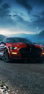 Red sports car on a mountain road at night under a dramatic sky.